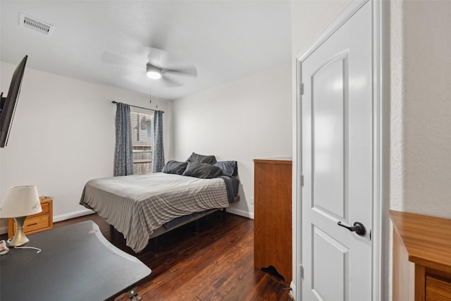 bedroom with ceiling fan, dark wood-style flooring, visible vents, and baseboards