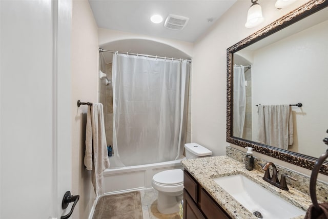 full bathroom featuring visible vents, toilet, shower / bath combo with shower curtain, vanity, and tile patterned flooring