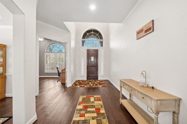 entrance foyer featuring baseboards, ornamental molding, and dark wood-style flooring