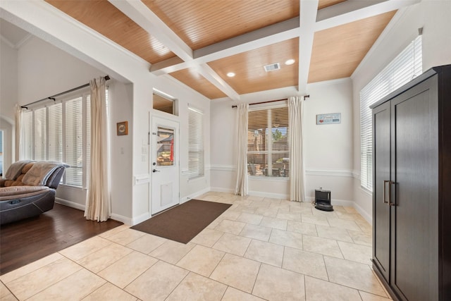 entrance foyer with wooden ceiling, a wealth of natural light, and beamed ceiling