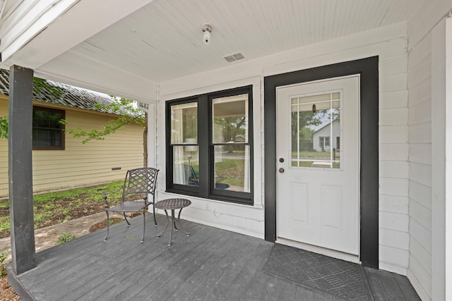 property entrance with visible vents and a porch