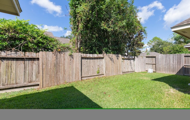 view of yard with a fenced backyard