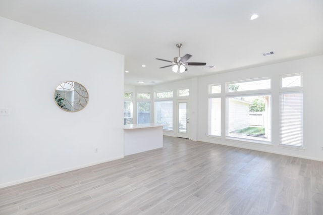 unfurnished living room with light wood-style floors, recessed lighting, visible vents, and a healthy amount of sunlight