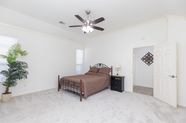 bedroom with vaulted ceiling, carpet floors, ornamental molding, and visible vents