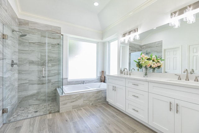 full bath featuring a stall shower, a garden tub, and a sink