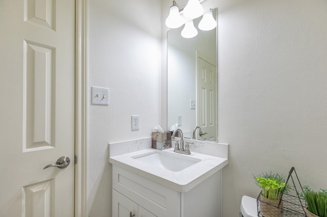 half bath featuring toilet and vanity