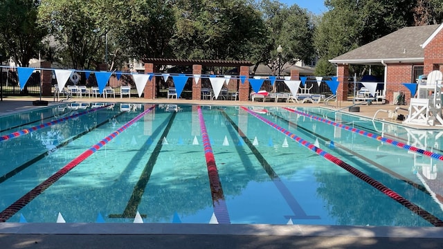 community pool featuring a patio area, fence, and a pergola