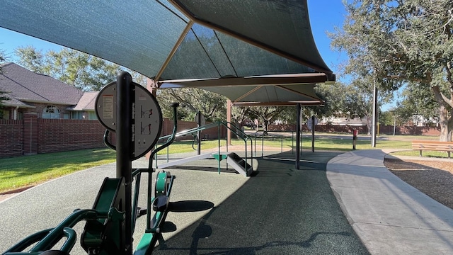 surrounding community with playground community, a yard, and fence