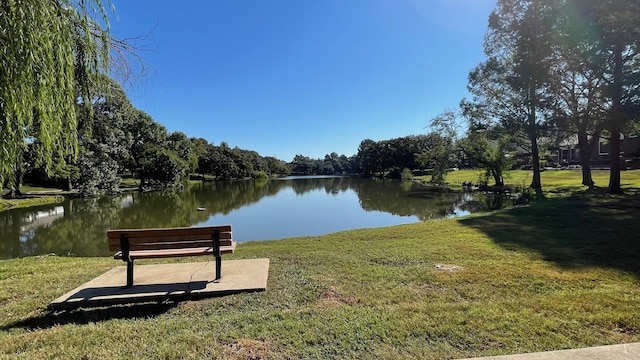 view of property's community featuring a water view and a lawn