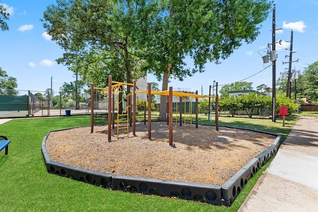 communal playground with fence and a lawn