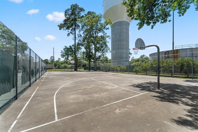 view of basketball court with community basketball court and fence