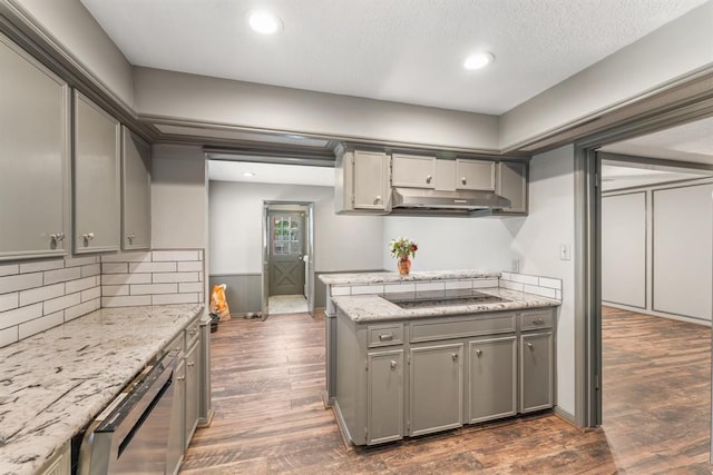 kitchen with dishwasher, under cabinet range hood, dark wood-type flooring, and gray cabinetry