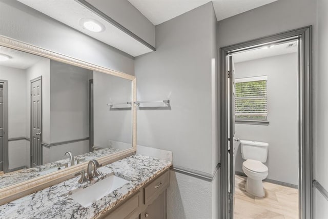 bathroom with toilet and vanity