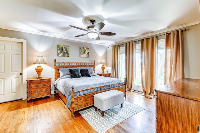 bedroom featuring ceiling fan, light wood-type flooring, and crown molding