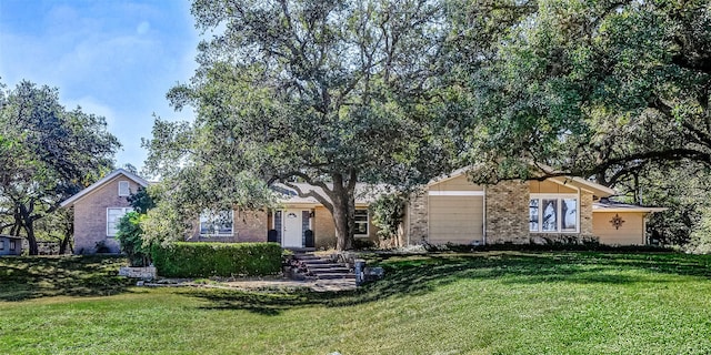 ranch-style house with brick siding and a front yard