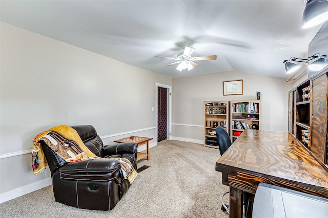 office space featuring vaulted ceiling, carpet flooring, a ceiling fan, and baseboards