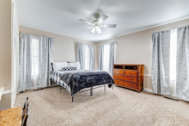 bedroom featuring carpet floors, visible vents, and a ceiling fan