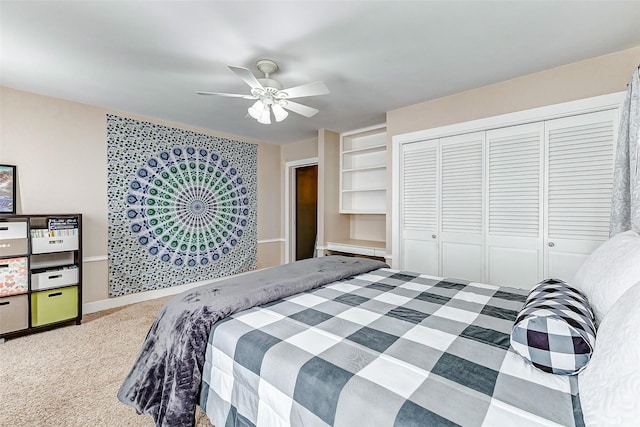 carpeted bedroom featuring baseboards, a ceiling fan, and a closet