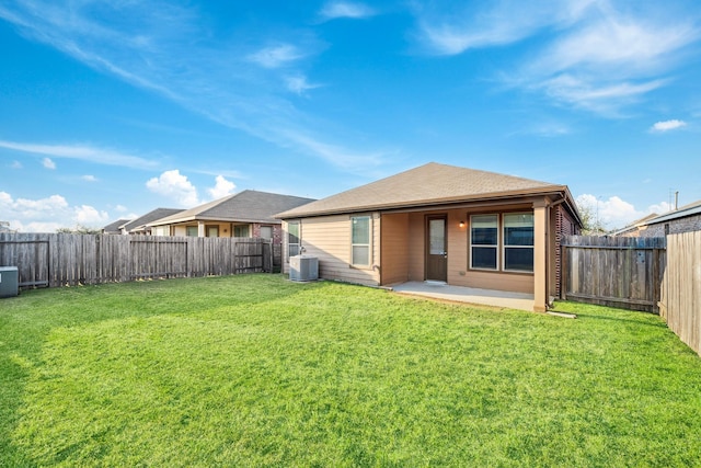 back of property with a patio area, a lawn, a fenced backyard, and central air condition unit