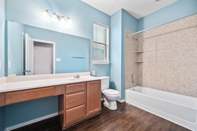 bathroom with toilet, shower / bathing tub combination, wood finished floors, and vanity