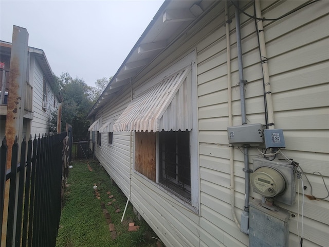 view of side of property featuring fence