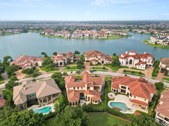 drone / aerial view with a water view and a residential view