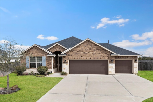 ranch-style house with a garage, fence, a front lawn, and roof with shingles