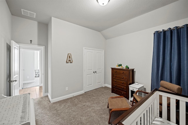 bedroom featuring lofted ceiling, carpet flooring, visible vents, and baseboards