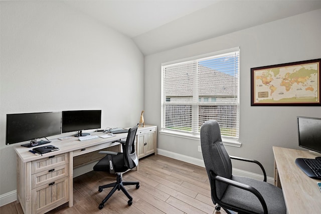 office with lofted ceiling, light wood finished floors, a wealth of natural light, and baseboards