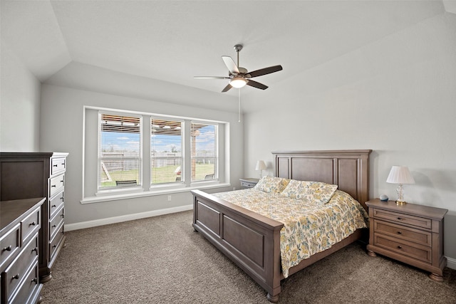 bedroom featuring ceiling fan, baseboards, dark carpet, and vaulted ceiling