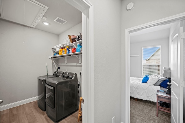 washroom with laundry area, visible vents, baseboards, washer and dryer, and attic access