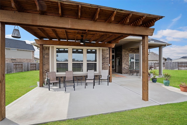 view of patio / terrace with ceiling fan and fence