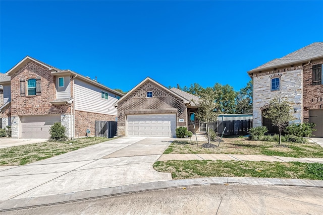 view of front of property with a garage, concrete driveway, stone siding, fence, and brick siding