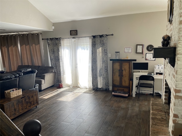 interior space with vaulted ceiling and dark wood-style flooring