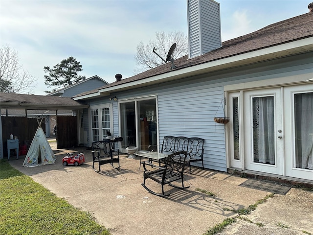 view of patio featuring french doors and fence