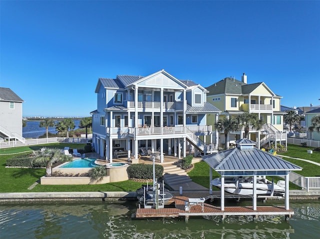 rear view of house featuring stairway, a water view, a patio, and boat lift