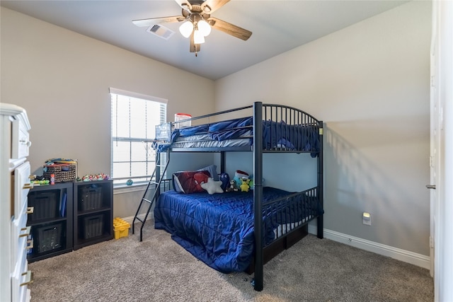 carpeted bedroom featuring baseboards, visible vents, and ceiling fan