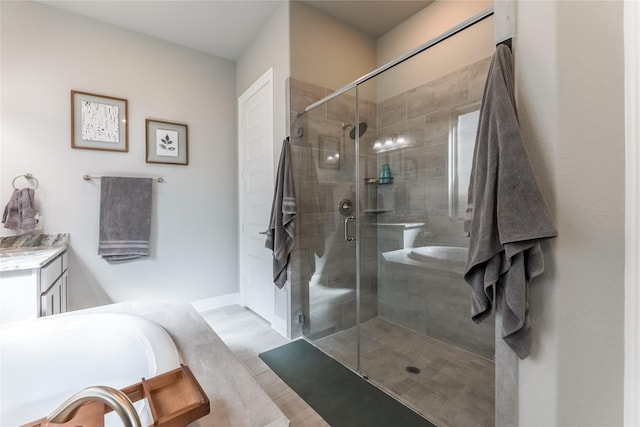 bathroom featuring a stall shower, vanity, and a bath