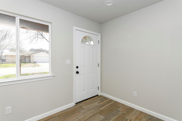 entryway with baseboards and wood finished floors