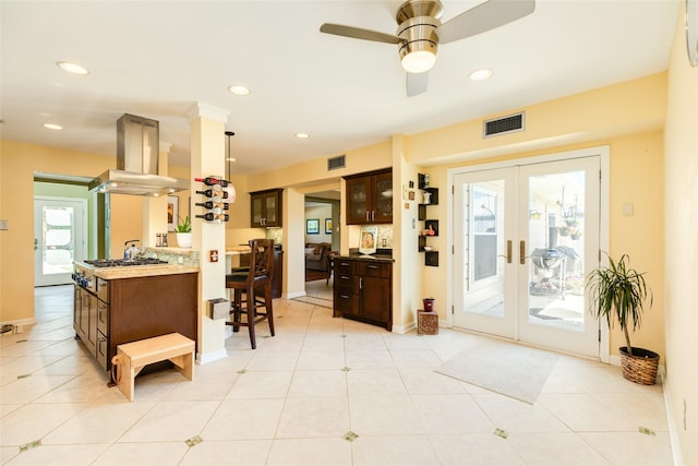 kitchen featuring recessed lighting, french doors, visible vents, and island range hood