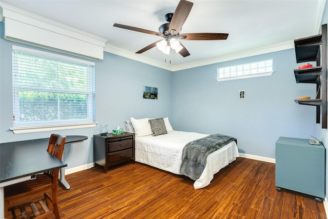 bedroom featuring baseboards, wood finished floors, and crown molding