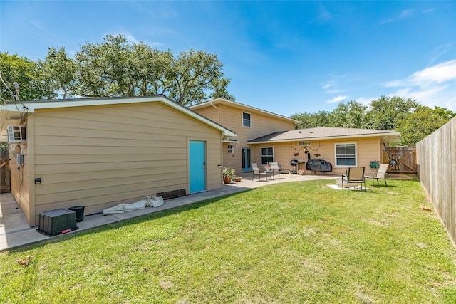 rear view of property with fence private yard, a patio area, and a yard