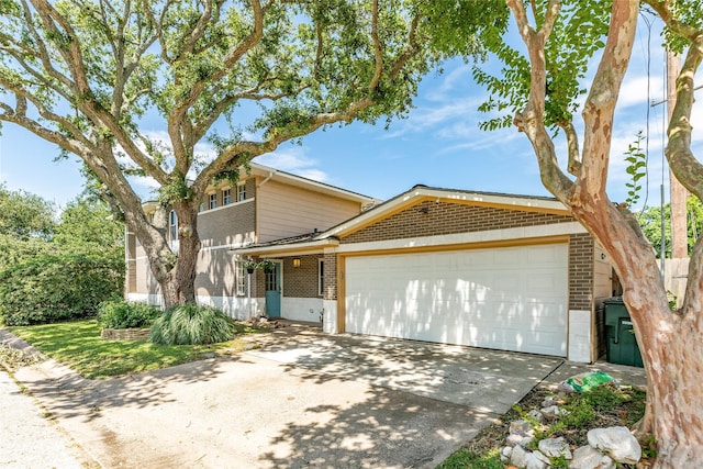 view of front of house with concrete driveway, brick siding, and an attached garage