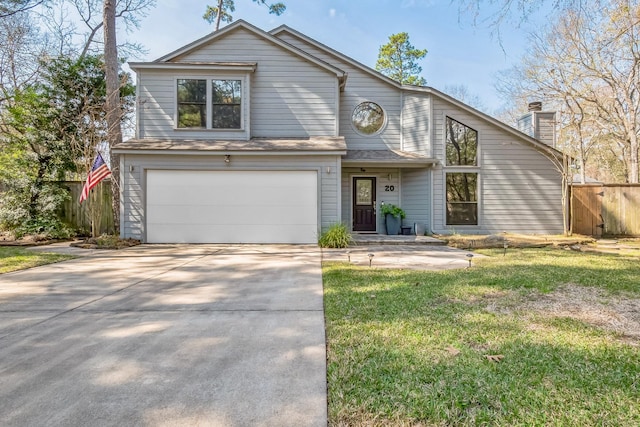 view of front of house with a garage, fence, driveway, and a front lawn