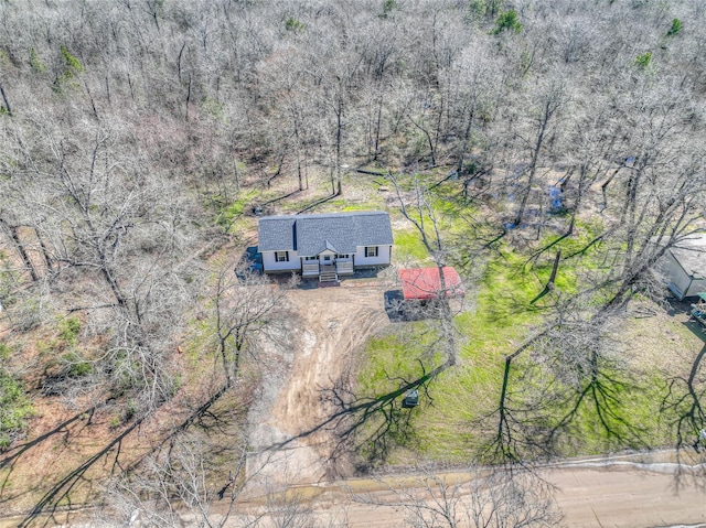 drone / aerial view featuring a forest view