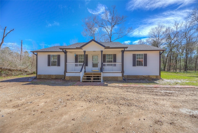 view of front of property with covered porch and a shingled roof