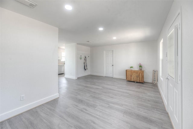 spare room with light wood-type flooring, visible vents, baseboards, and recessed lighting