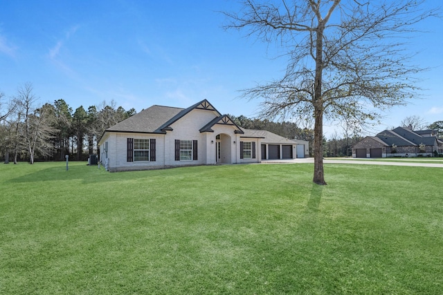 french country inspired facade with a garage, driveway, a front lawn, and a shingled roof