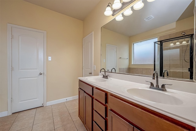 full bathroom with tile patterned flooring, a shower stall, visible vents, and a sink