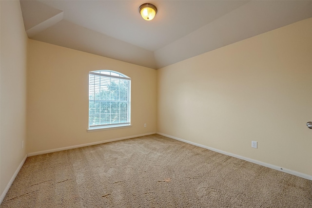 unfurnished room with vaulted ceiling, carpet, and baseboards